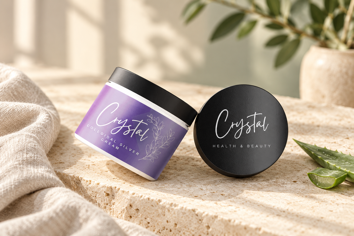 Crystal Colloidal Silver Cream purple jar and black lid on a cream stone surface beside aloe and linen