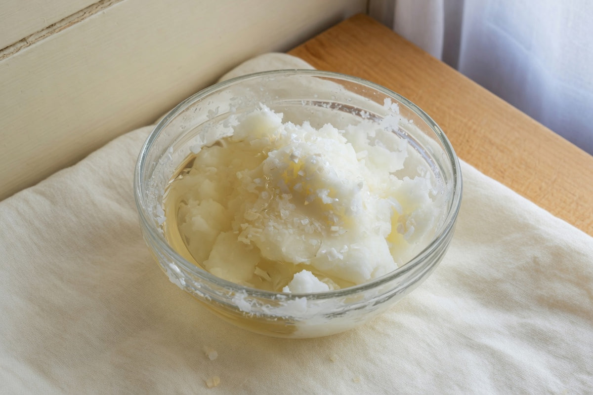 Cold pressed coconut oil beginning to melt to a clear liquid