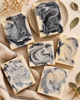 Six handmade colloidal silver and activated charcoal soap bars, each with a different charcoal marble