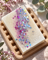 Frosted Rhubarb and Rose colloidal silver soap on a wooden dish with pink and iridescent glitter