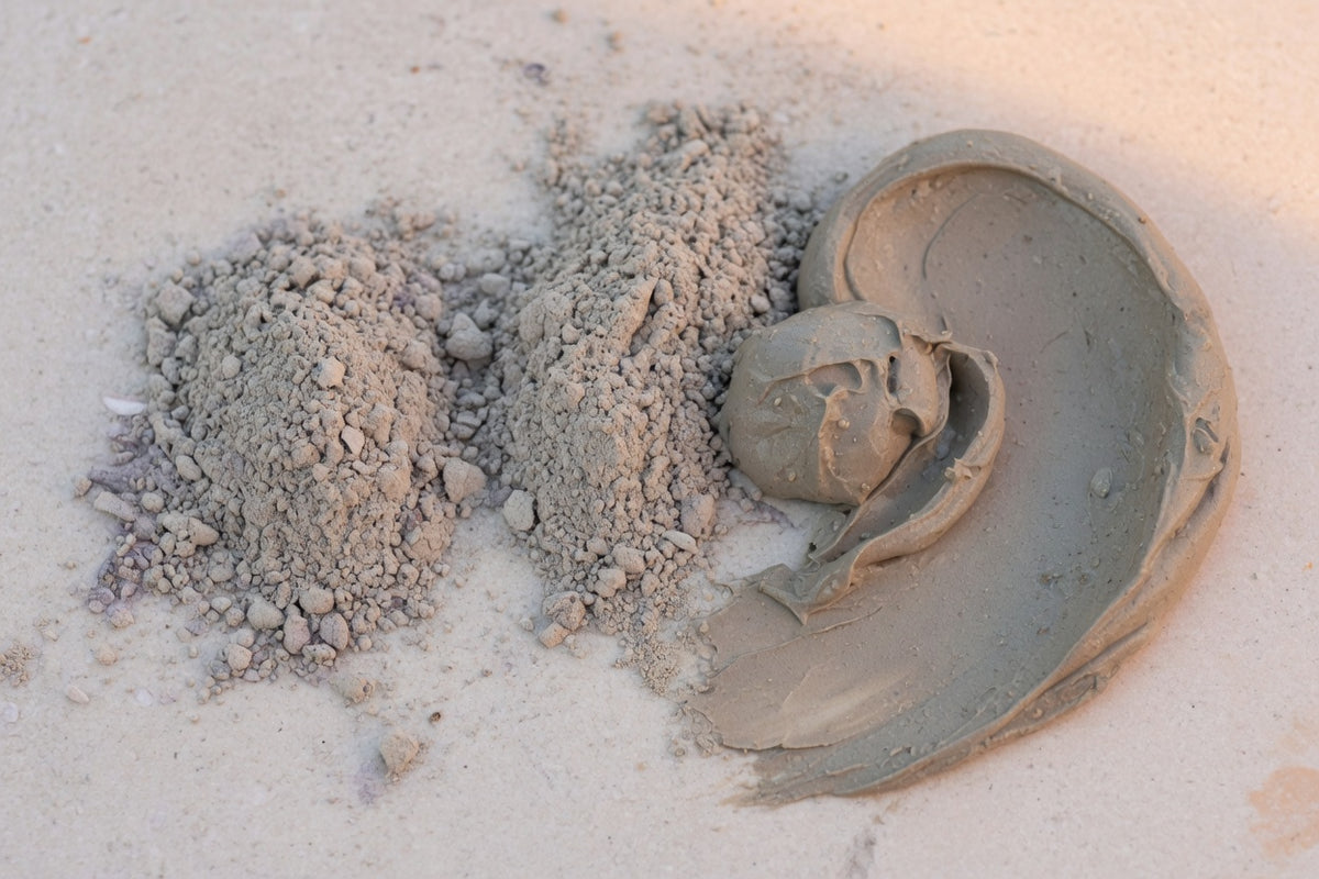 Grey-beige bentonite clay powder beside a smooth clay paste.