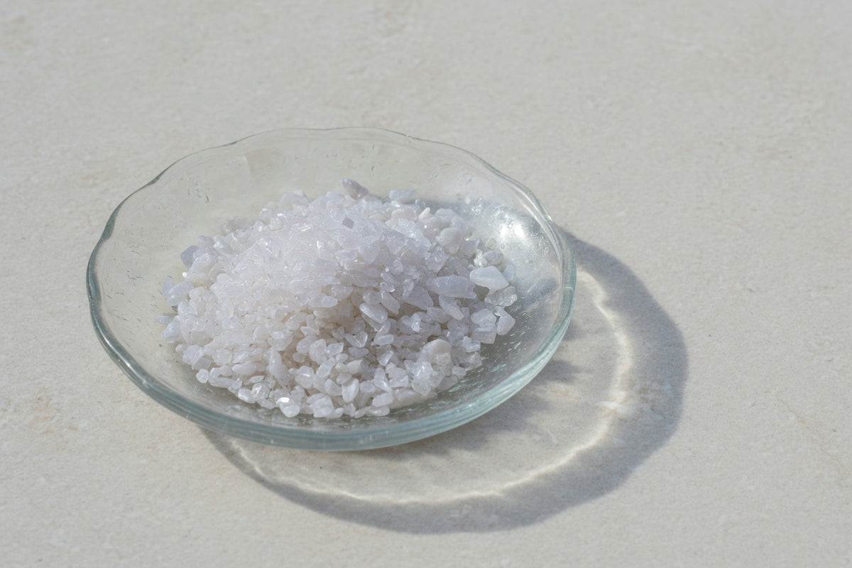 Fine white powder in a glass dish on limestone.