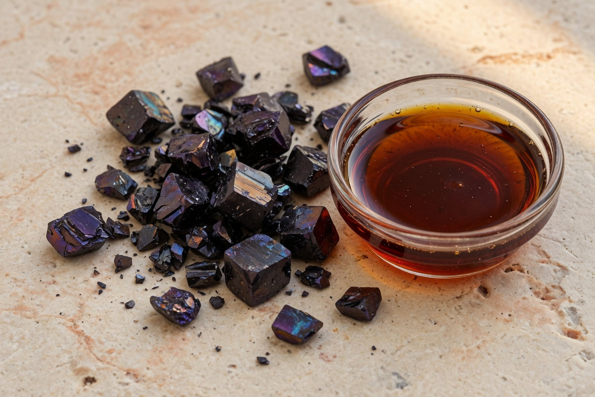 Dark violet-black iodine crystals beside a glass dish of deep amber solution.