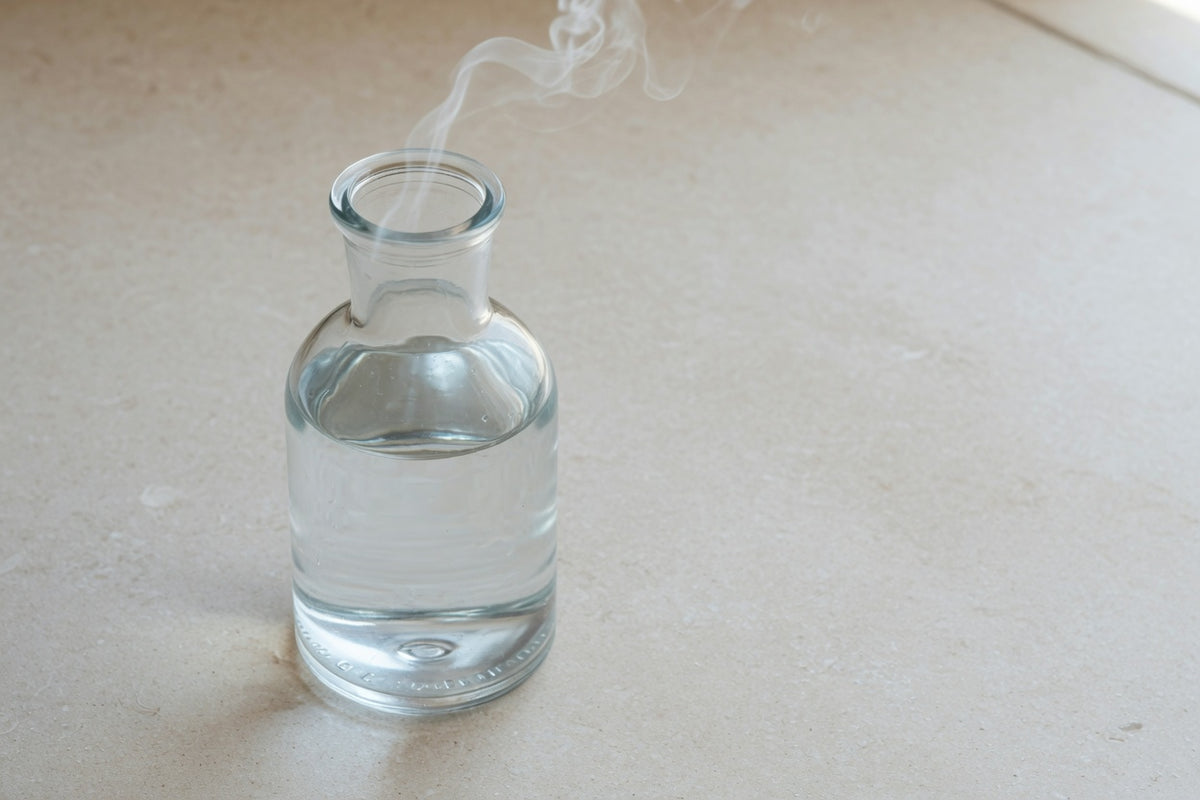 Clear water in a glass on pale limestone.