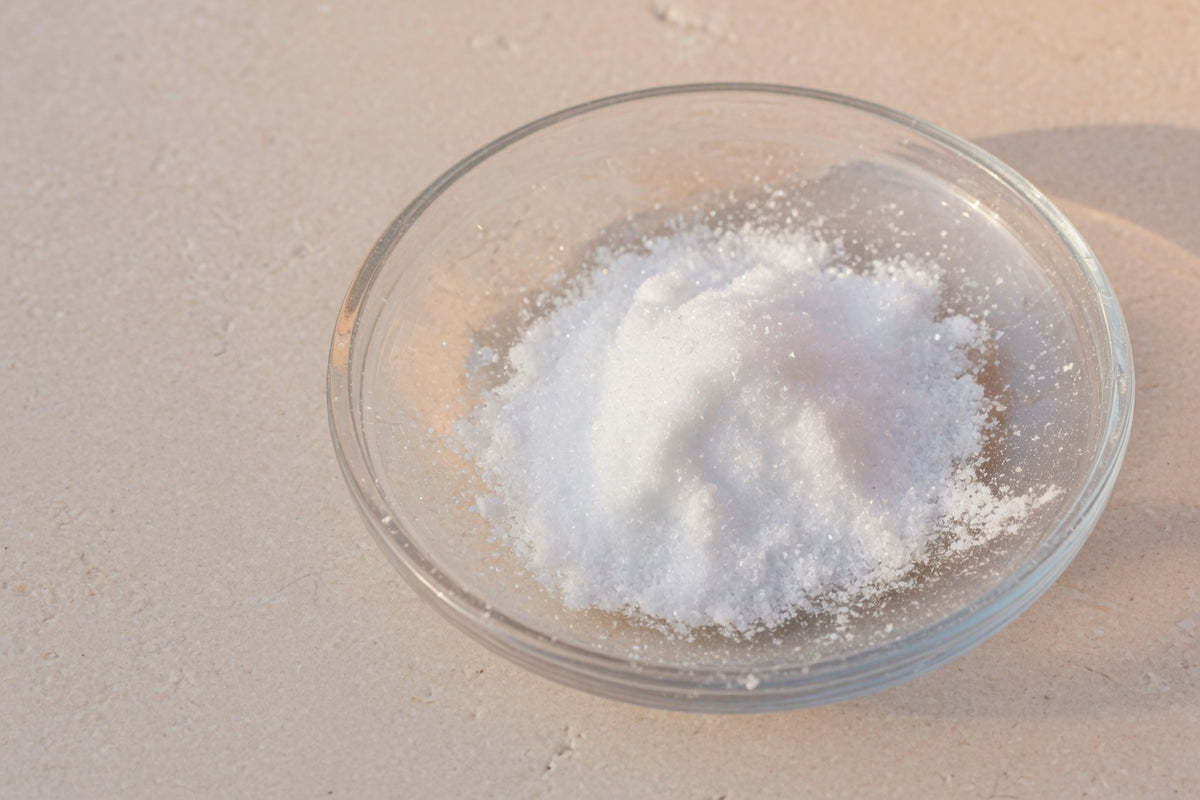 Fine white powder in a glass dish on limestone, with no fruit.