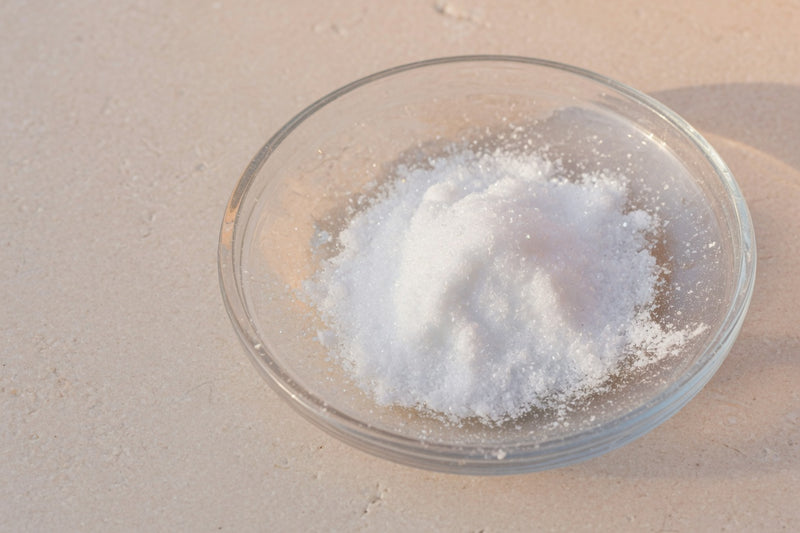 Fine white powder in a glass dish on limestone, with no fruit.