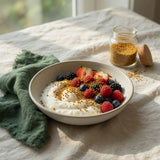 Breakfast bowl of yoghurt and berries topped with organic bee pollen granules