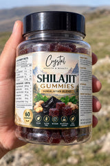 Hand holding a jar of Crystal Health Himalayan Shilajit Gummies, 60 gummies